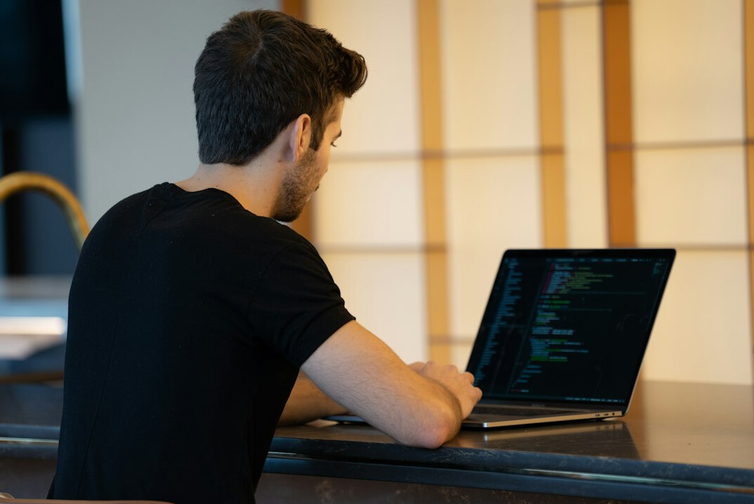 person learning coding on laptop