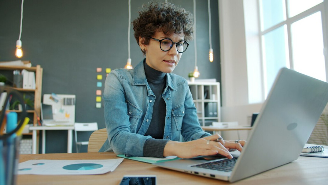 person working on laptop at desk