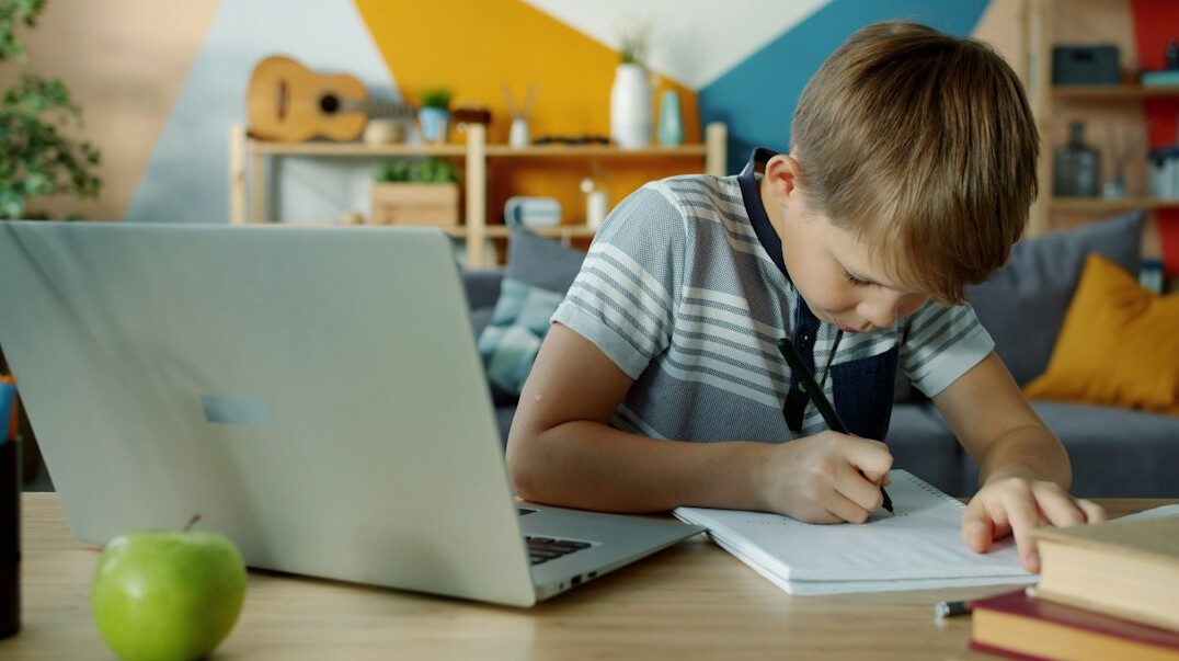 young person coding on laptop