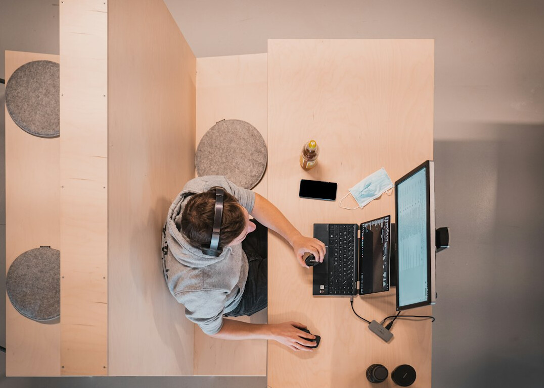 person coding at home desk