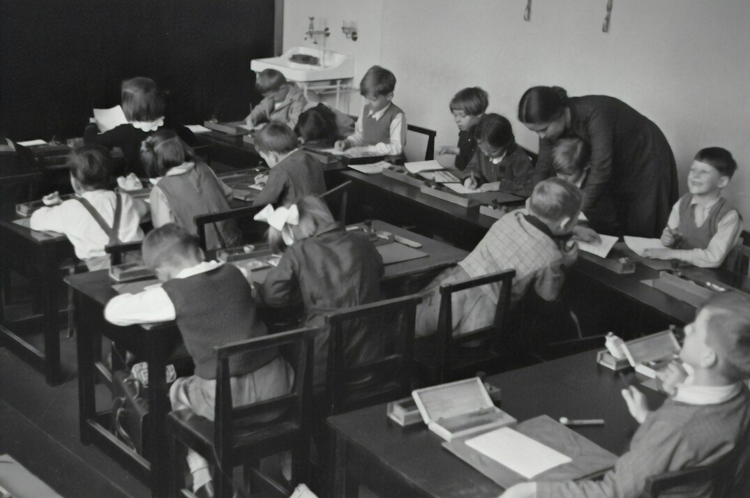 Students sitting at computers in a modern programming classroom
