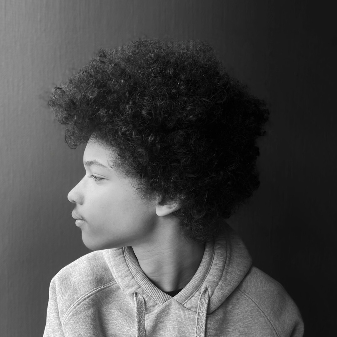 Studio portrait of a young male mentor with curly hair
