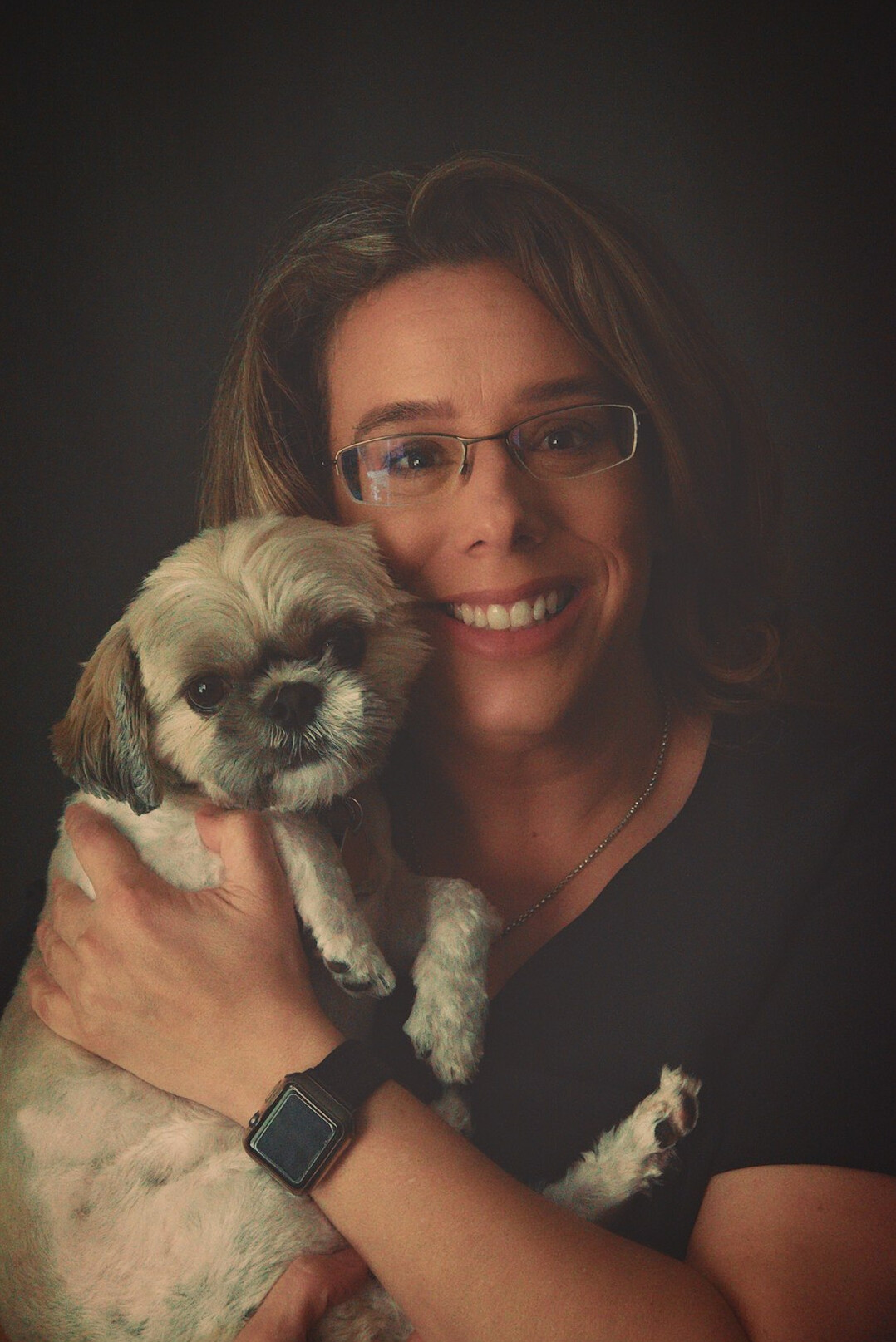 Studio portrait of a smiling female mentor with glasses